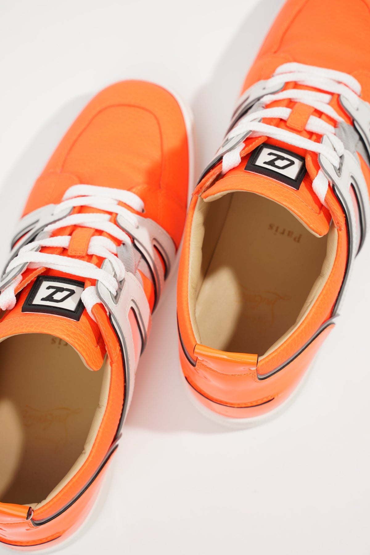 Orange on sale louboutin sneakers