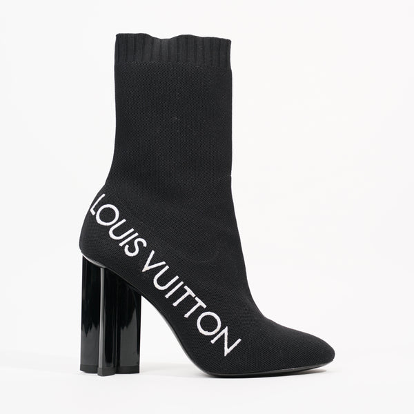 White landscape ankle boots by Louis Vuitton as a detail of
